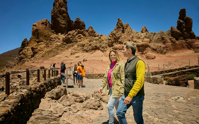 Guests walking on Mount Teide guided tour with rocky landscape in Tenerife.
