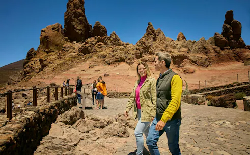 Guests walking on Mount Teide guided tour with rocky landscape in Tenerife.