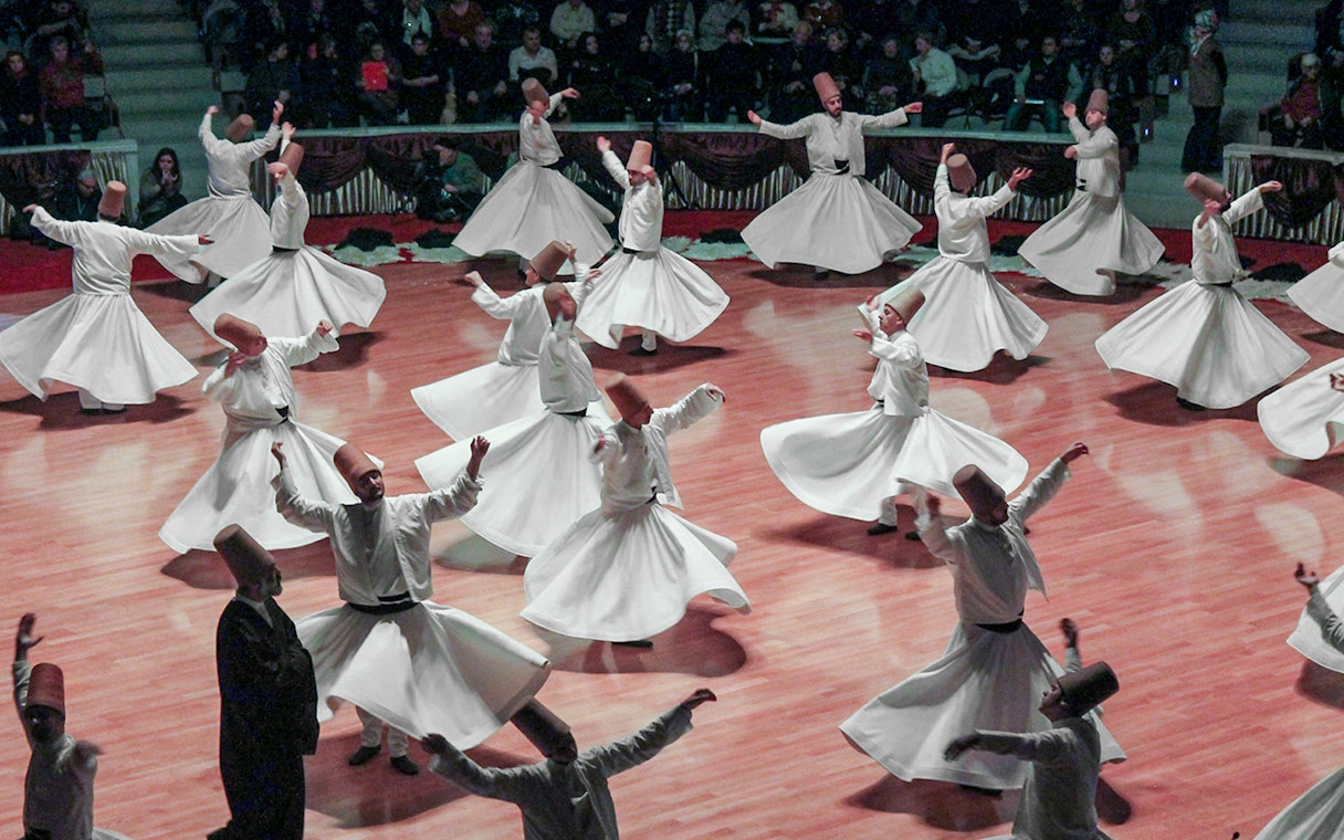 Whirling dervishes performing in Cappadocia, Turkey, showcasing traditional Sufi dance.