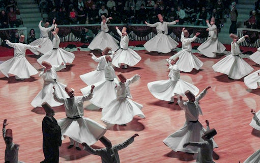 Whirling dervishes performing in Cappadocia, Turkey, showcasing traditional Sufi dance.