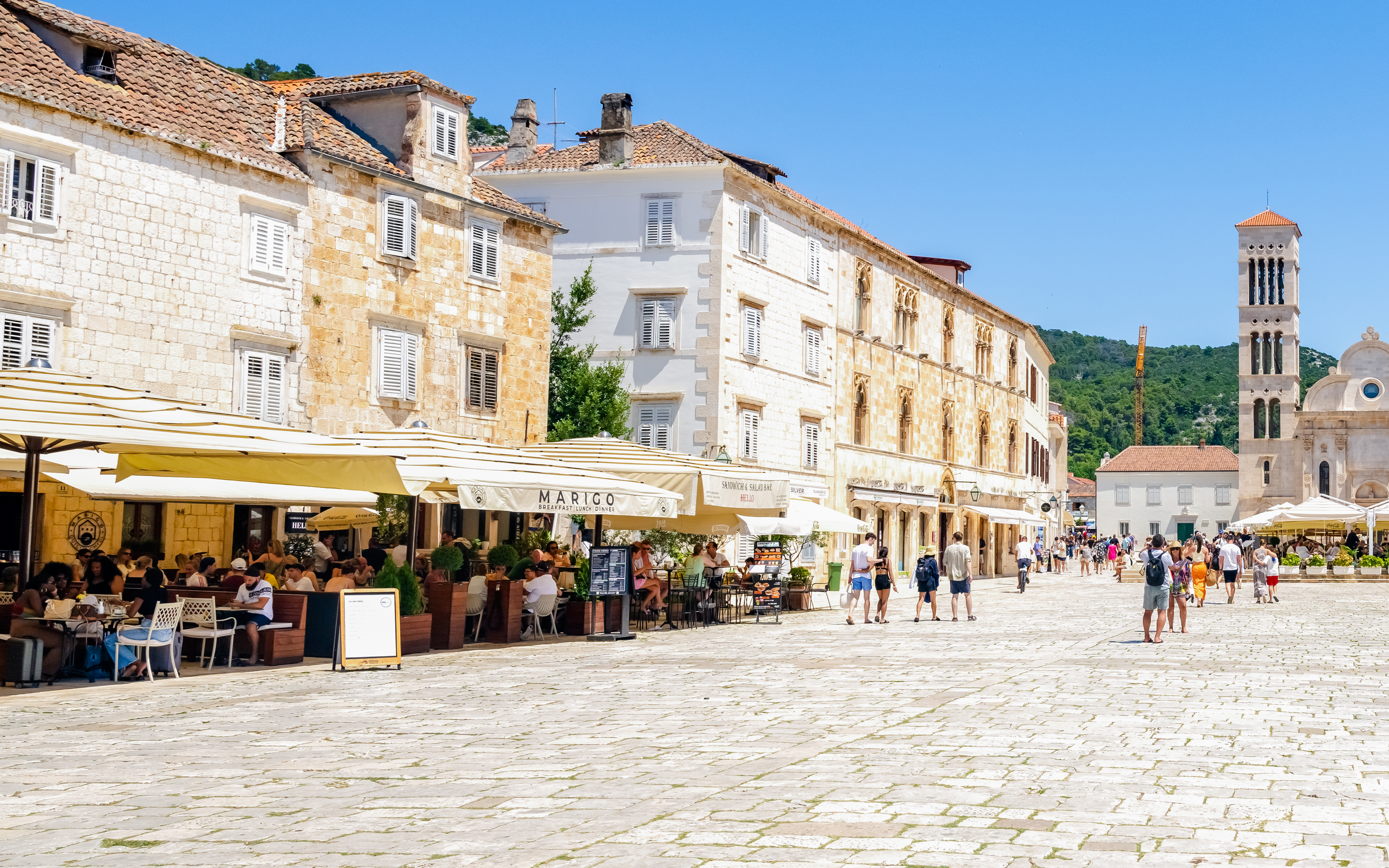 Historic square with cafes and stone buildings on Hvar Island, Croatia.