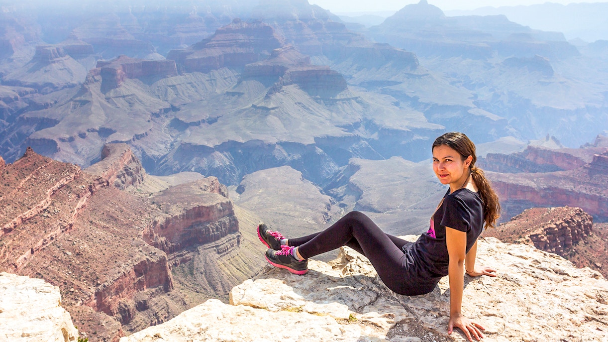 Woman sitting at Shoshone Point overlooking the Grand Canyon.