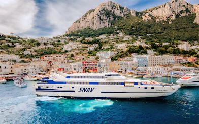 SNAV ferry sailing from Naples Beverello to Capri with island landscape in background.