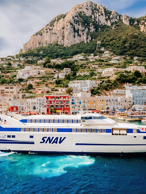 SNAV ferry sailing from Naples Beverello to Capri with island landscape in background.