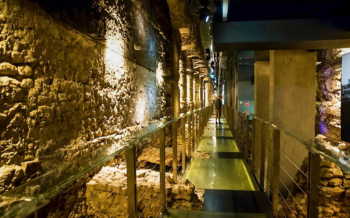 Rynek Underground passageway in Krakow with ancient stone walls.