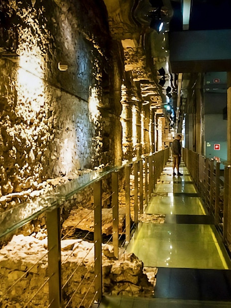 Rynek Underground passageway in Krakow with ancient stone walls.