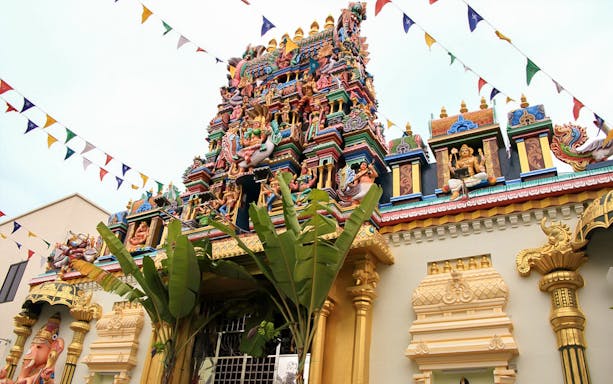 Colorful Sri Mahamariamman Temple facade in Penang, Malaysia, with intricate sculptures.