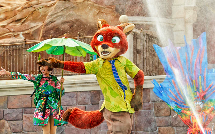 Character performance at Shanghai Disney with colorful costumes and water effects.