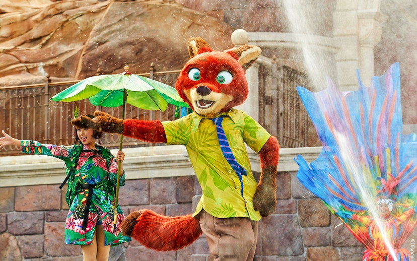 Character performance at Shanghai Disney with colorful costumes and water effects.