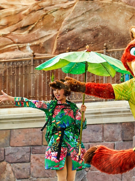 Character performance at Shanghai Disney with colorful costumes and water effects.