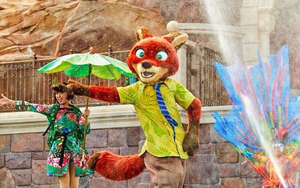 Character performance at Shanghai Disney with colorful costumes and water effects.