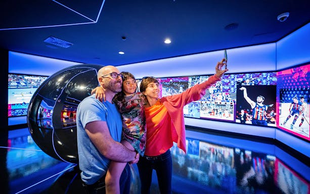 Family taking a selfie at FC Barcelona museum exhibit during Christmas Total Xperience.