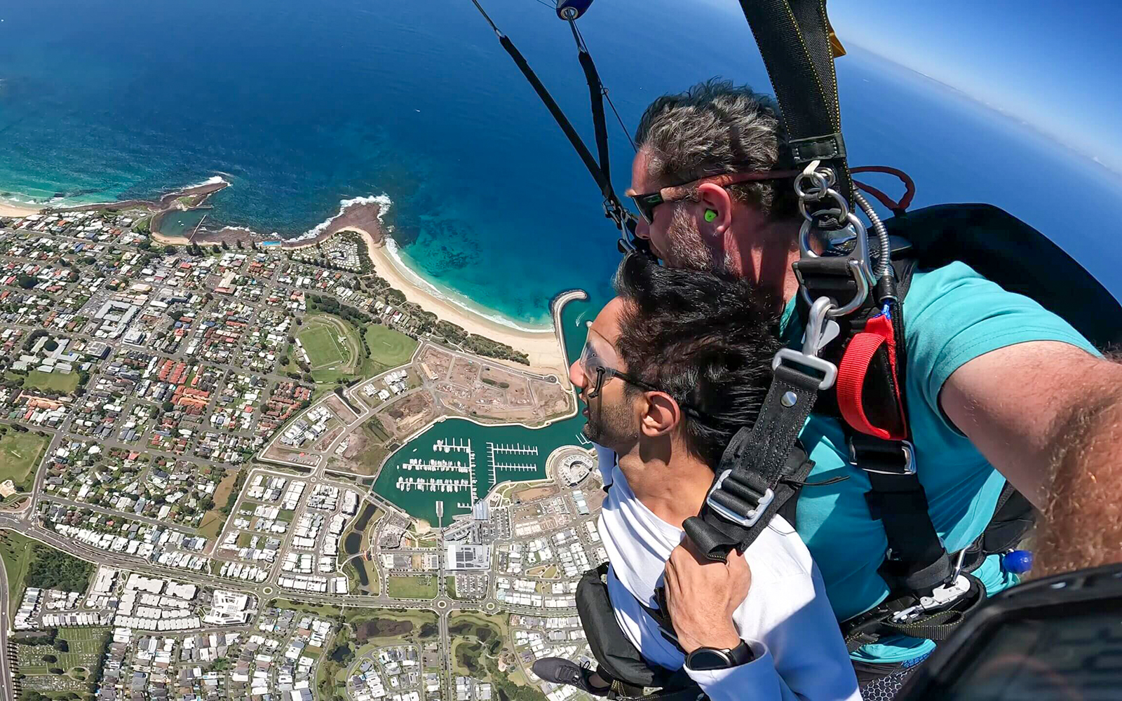 Tandem skydive over Shellharbour, Sydney, with ocean and coastline view from 15,000ft.
