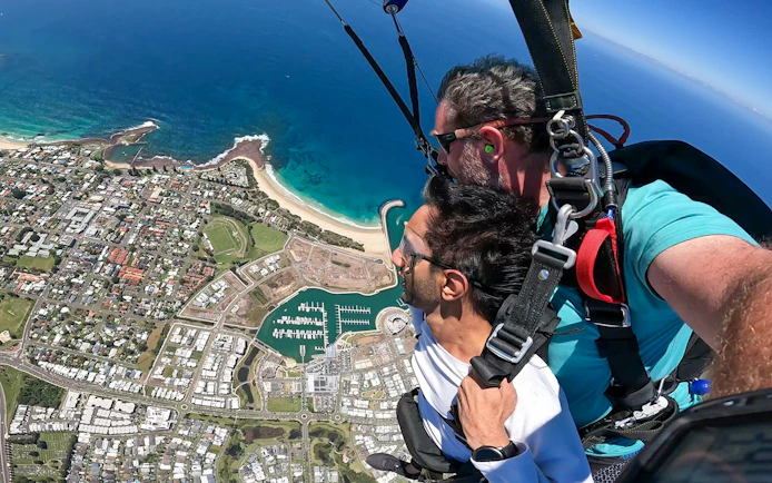 Tandem skydive over Shellharbour, Sydney, with ocean and coastline view from 15,000ft.