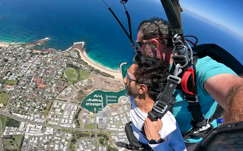 Tandem skydive over Shellharbour, Sydney, with ocean and coastline view from 15,000ft.