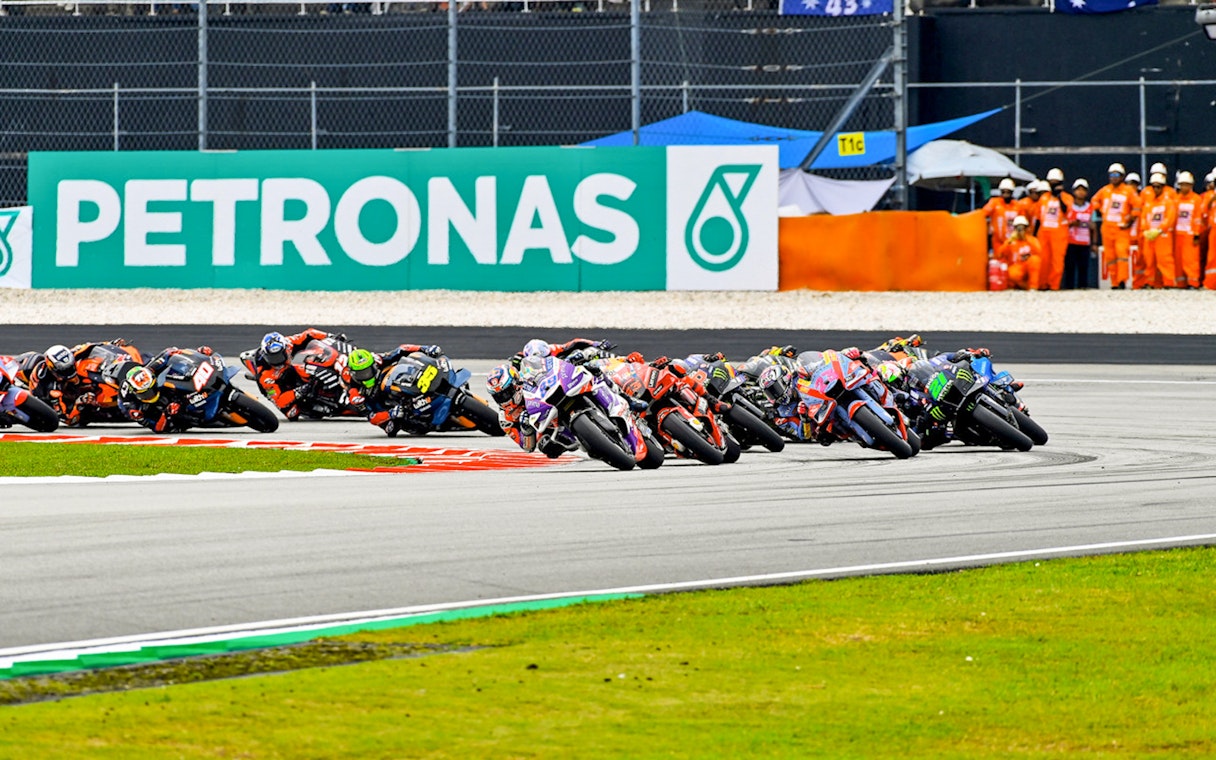 Motorcycle racers taking a sharp turn at Petronas Grand Prix of Malaysia 2023.