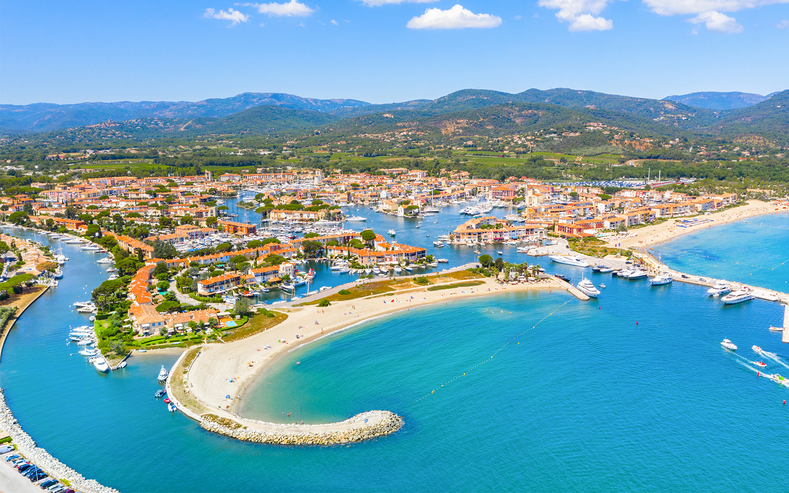 Aerial view of Port Grimaud with canals, boats, and sandy beaches on the St Tropez day tour from Nice.