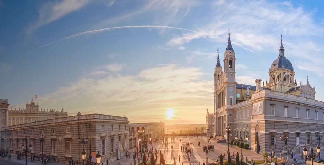 Royal Palace of Madrid with tourists exploring the historic architecture.