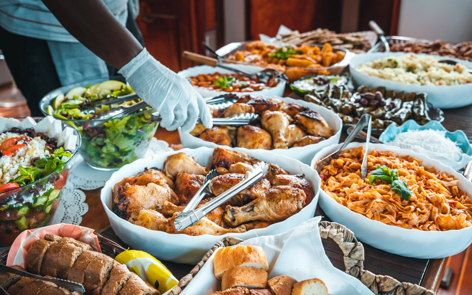 Mediterranean Greek buffet with salads, roasted chicken, and pasta on a cruise.