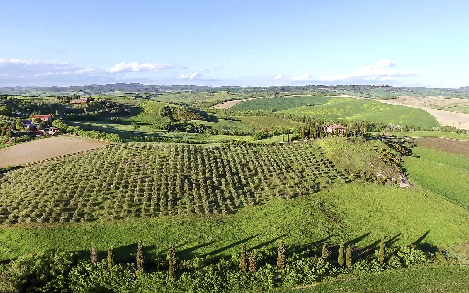 Aerial view of Chianti winery with vineyards and Tuscan landscape.