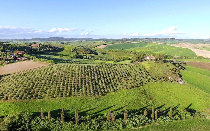 Aerial view of Chianti winery with vineyards and Tuscan landscape.