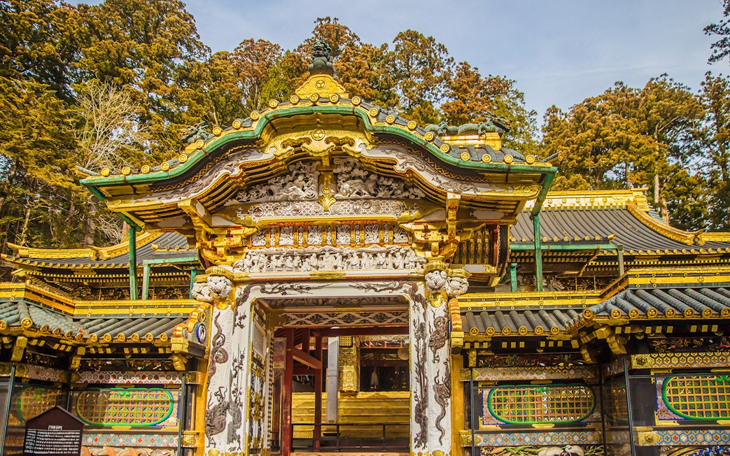 Toshogu Shrine ornate gate with intricate carvings and gold accents in Nikko, Japan.