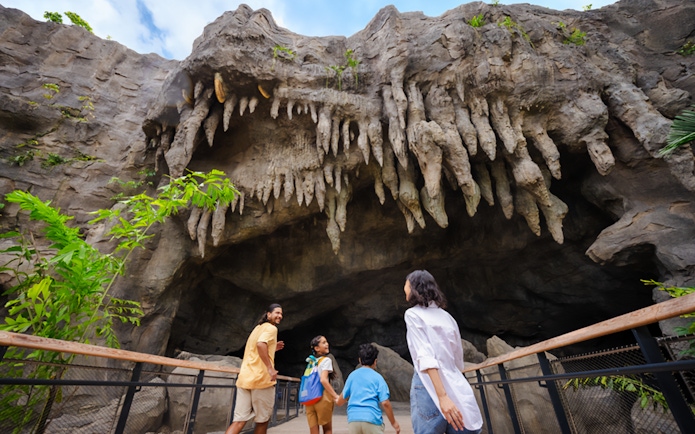 Family exploring cave entrance with stalactites at The Cavern.