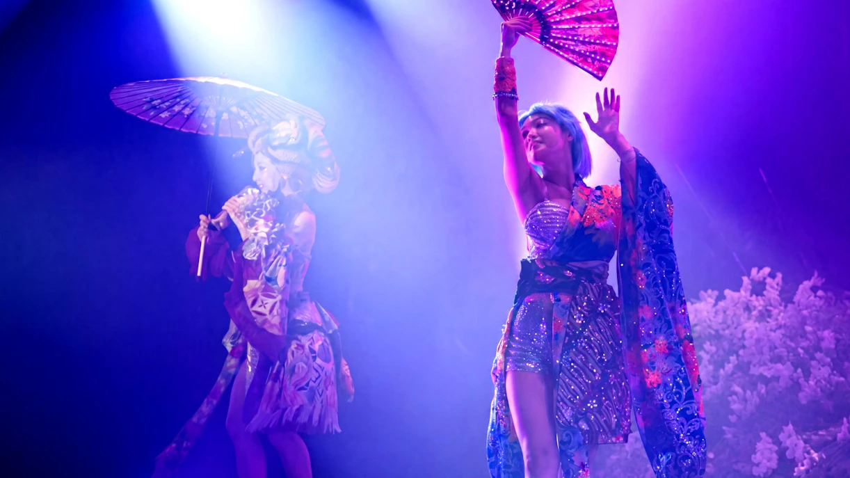 Performers in traditional attire with umbrellas during a Samurai show in Kabukicho, Shinjuku, Tokyo.