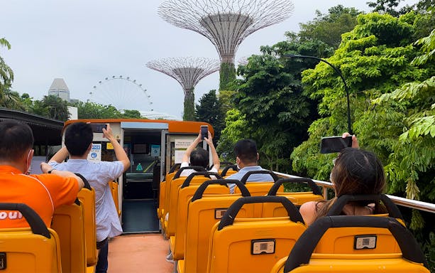 Open-top bus tour in Singapore with views of Supertree Grove and Singapore Flyer.