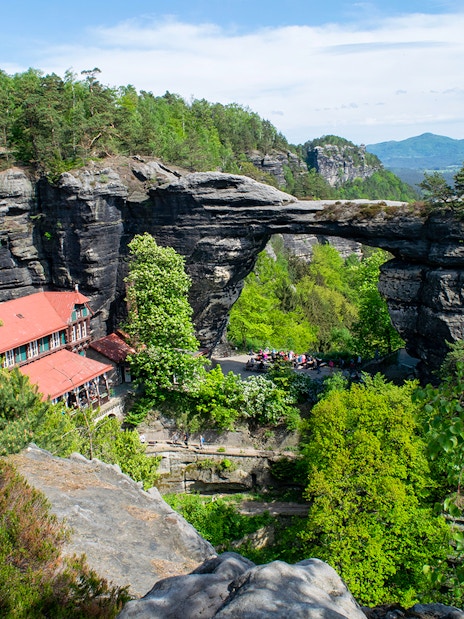 Pravčická Brána rock arch surrounded by lush greenery in Bohemian Switzerland.