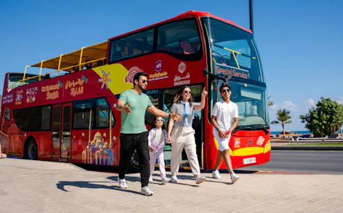 Family exiting HOHO City Sightseeing Bus in Sharjah, enjoying a sunny day tour.