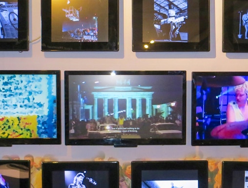 Berlin Wall Museum exhibit featuring art and historical photos.