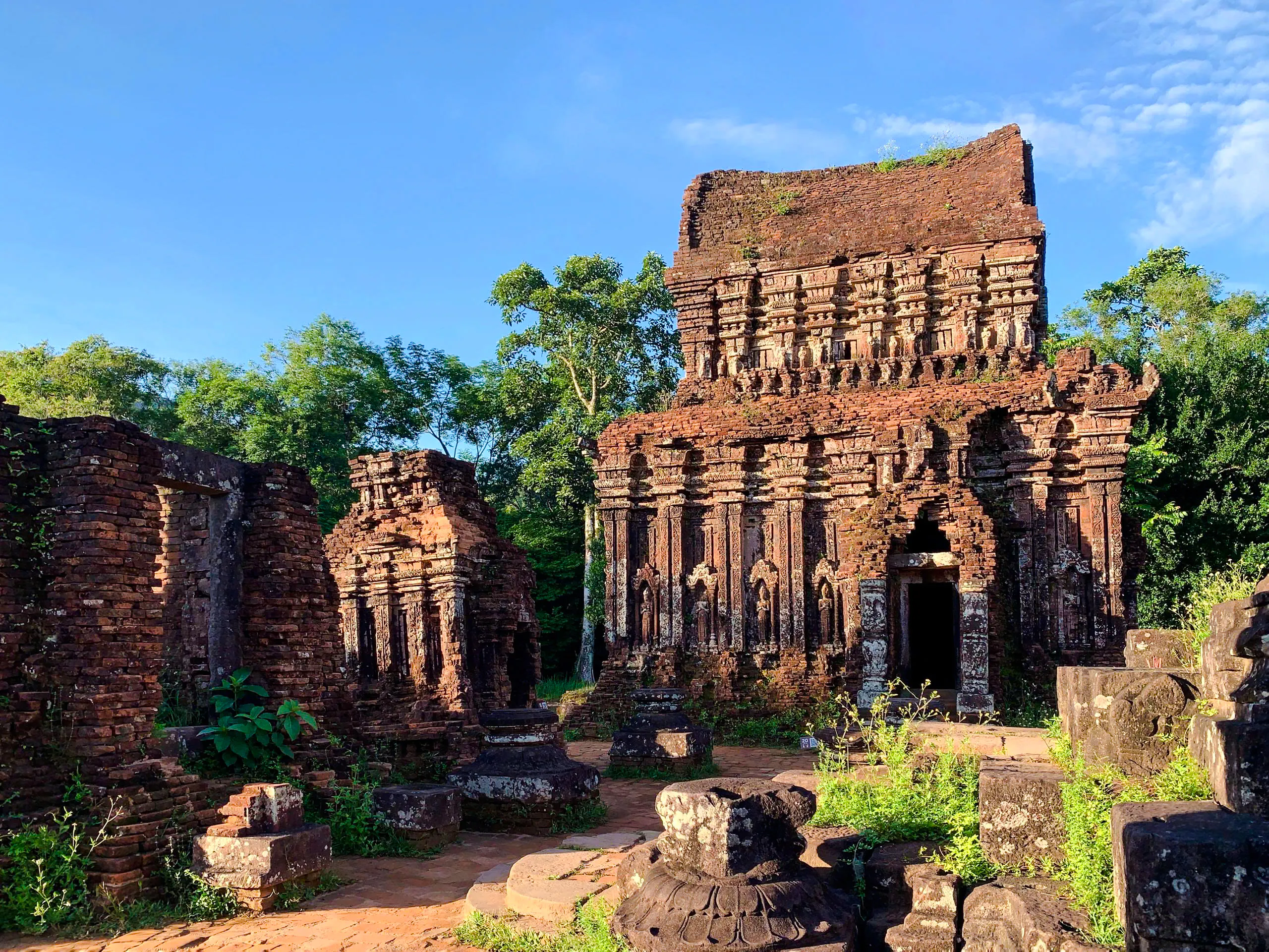 Ancient brick temple ruins at My Son Sanctuary, surrounded by greenery, Hoi An.