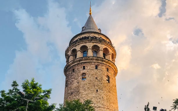 Galata Tower in Istanbul against a cloudy sky.