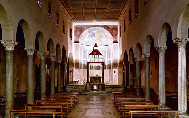 Interior of Basilica of San Giorgio in Velabro, Rome, with arches and altar.
