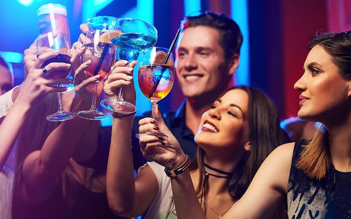 People toasting with drinks at OWL Osaka Nightclub.