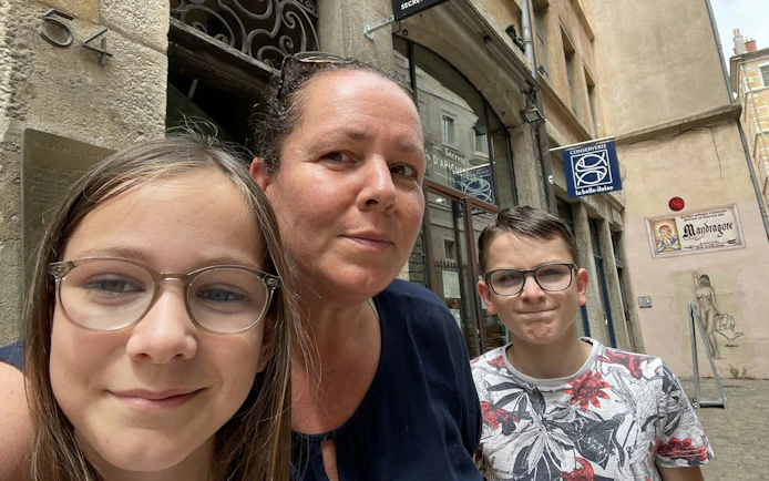 Family exploring a street in Lyon Old Town during a self-guided city exploration game.