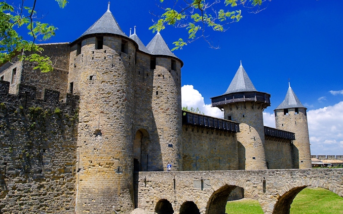 Carcassonne Castle stone towers and walls under a clear blue sky.
