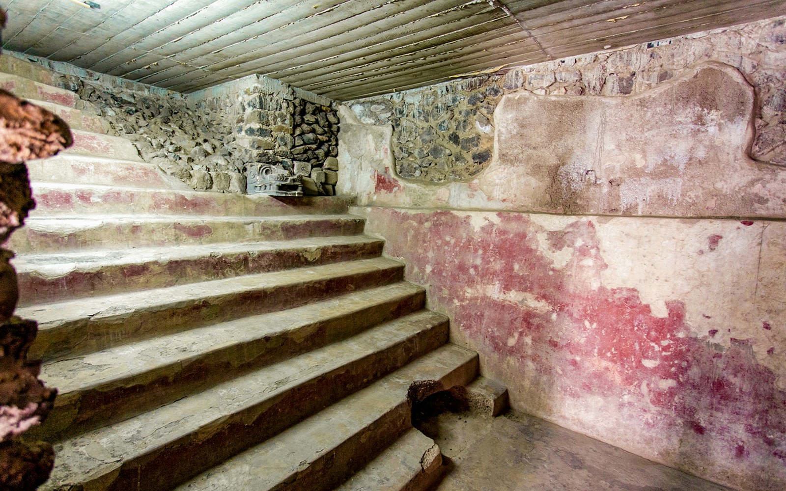 Stone steps and red murals inside the Jaguar Palace, Teotihuacan, Mexico.
