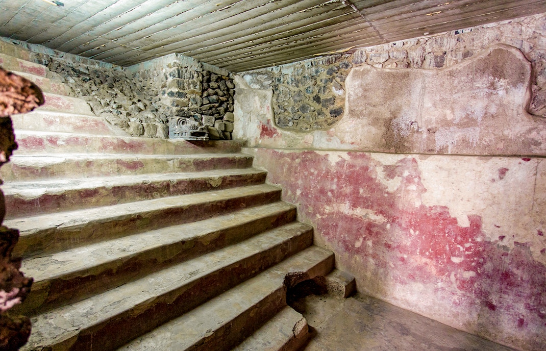Stone steps and red murals inside the Jaguar Palace, Teotihuacan, Mexico.