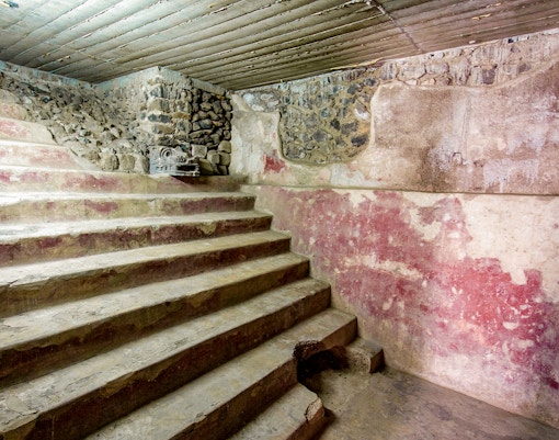 Stone steps and red murals inside the Jaguar Palace, Teotihuacan, Mexico.