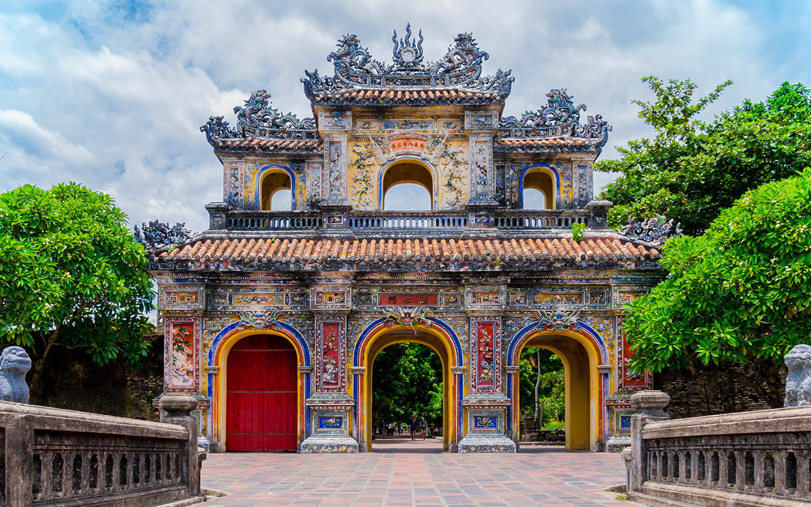 Main gate of the imperial forbidden purple city in Hue, Vietnam, with ornate architecture.