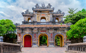 Main gate of the imperial forbidden purple city in Hue, Vietnam, with ornate architecture.