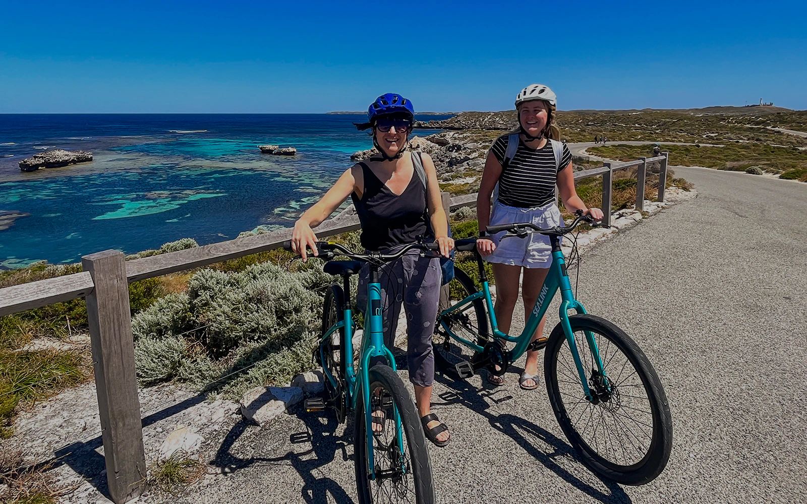 Cyclists on Rottnest Island with ocean view, accessible via ferry from Perth or Fremantle.