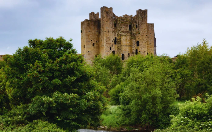 Trim Castle surrounded by lush greenery in County Meath, Ireland.