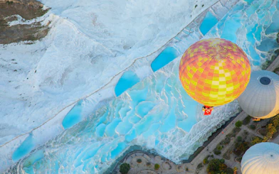 Aerial view of hot air balloons over Pamukkale travertines in the morning, Turkey.