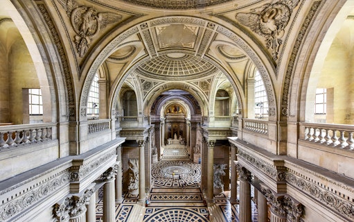 Interior view of the Pantheon in Paris, showcasing ornate architecture and detailed carvings.
