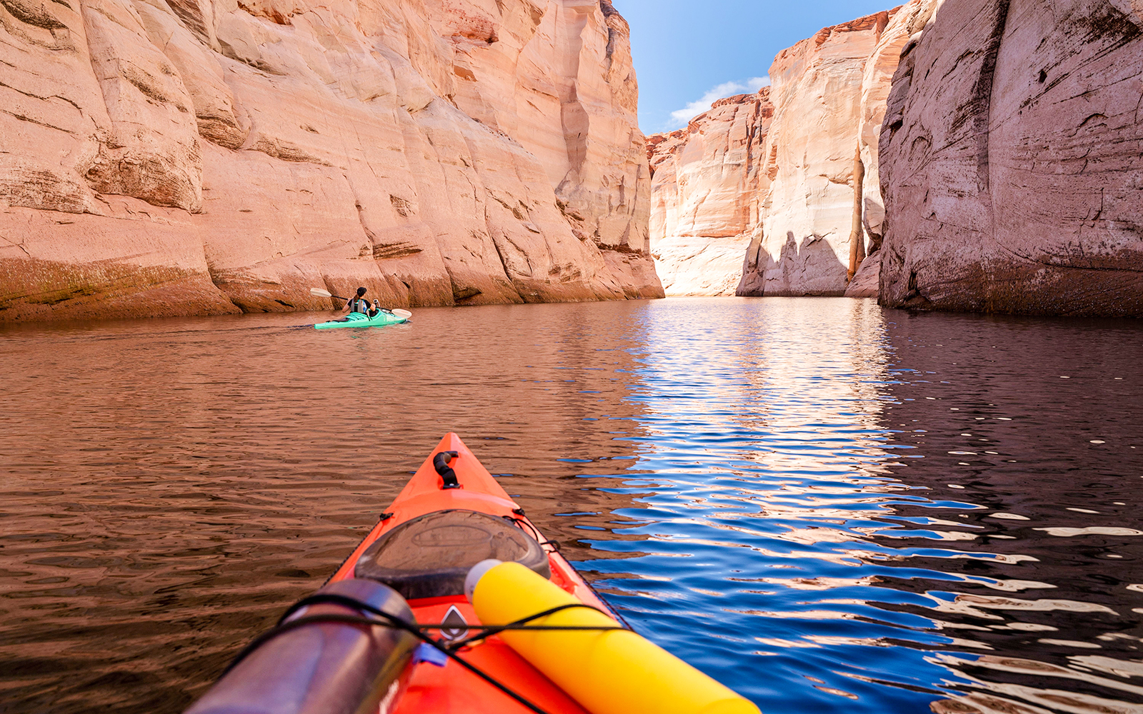 Kayaking through narrow canyon walls on Lake Powell.
