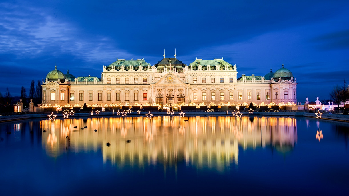 Palace Belvedere illuminated at night with reflections in the pond, Vienna, Austria.