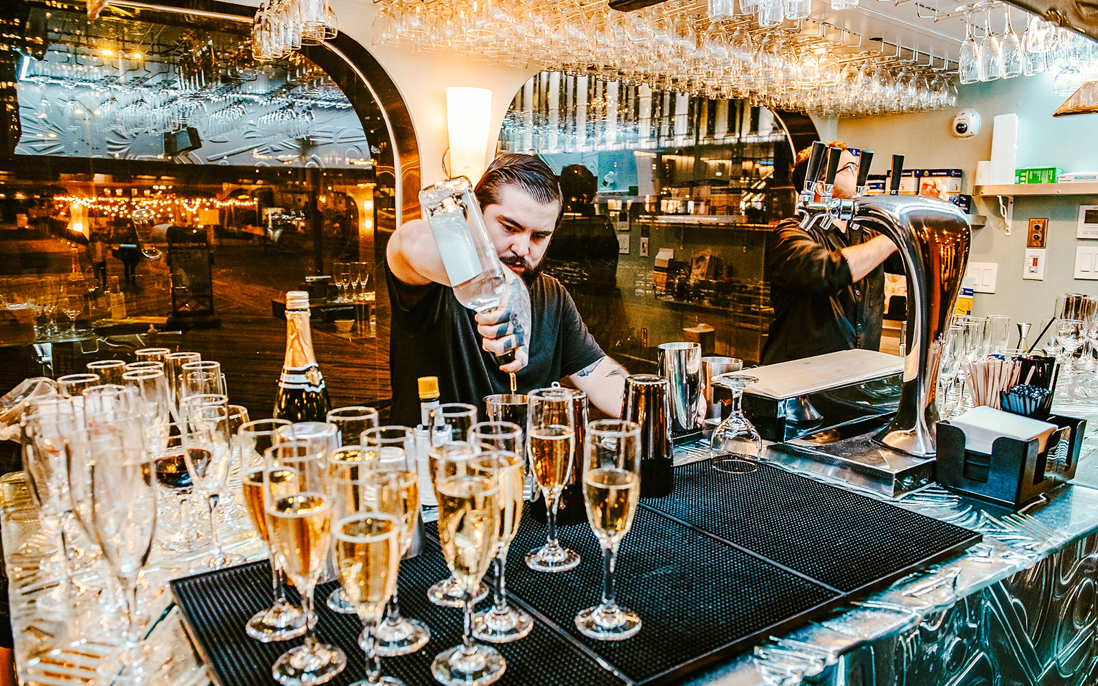 Bartender preparing drinks on New Year's Eve dinner cruise.